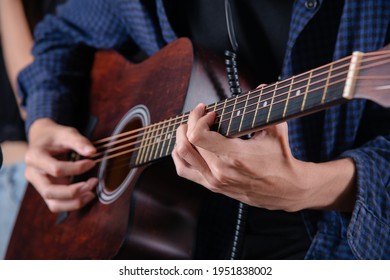 Close Up Of Man Hand Playing Acustic Guitar 