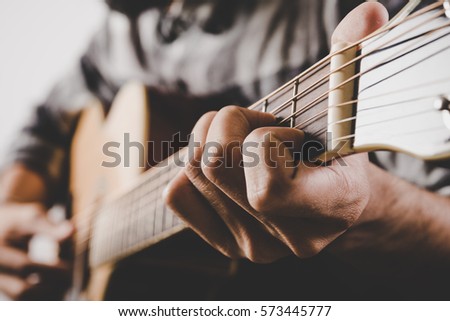 Close up of man hand playing guitar. 