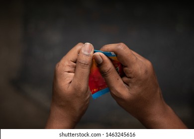 Close Up Of A Man Hand Tearing The Chewing Tobacco, Gutka Or Gutkha In India.