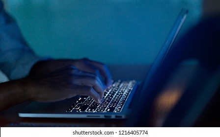 Close Up Man Hand Typing Keyboard Input Code For Register System Structure Or Unlock Password On Laptop In Darkness Operation Room, Cyber Security Concept