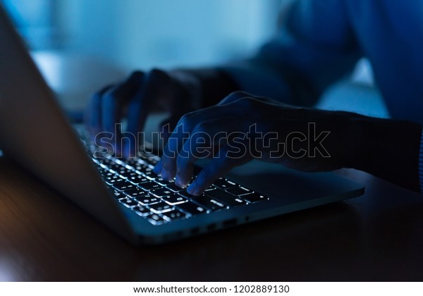 close up man\
hand typing keyboard input code for register system structure or\
unlock password on laptop in darkness operation room, cyber\
security and work from home\
concept