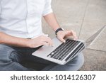 Close up man hand using computer outdoor - business, technology, social network concept