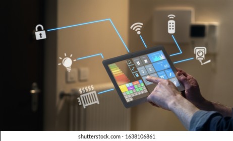 Close up of a man hand is using a futuristic latest innovative technology glass tablet with augmented reality holograms as a remote control of smart home appliances at home or office. - Powered by Shutterstock