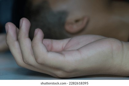 Close up of man hand.Losing consciousness to a sudden and temporary loss of awareness or responsiveness. It can be caused by various factors, including trauma, illness, and dehydration.