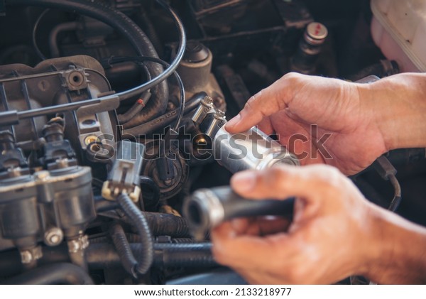 Close up Man hands fixing Car machinery vehicle\
mechanical service. Mechanic man hands repairing car auto repair\
shop. open vehicle hood checking up auto mobile. Vehicle Car\
maintenance engineer.
