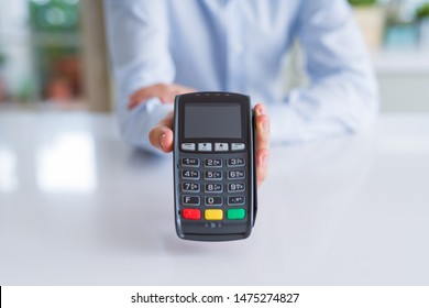 Close up of man hands holding pos terminal - Powered by Shutterstock