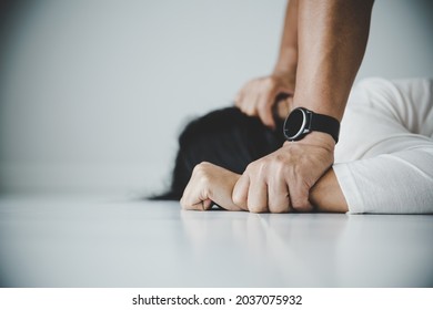 Close up of man hands holding a woman hands for rape and sexual abuse concept.