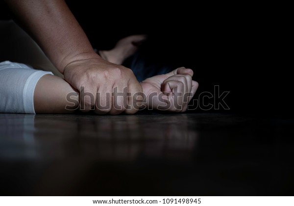 Close up of man hands holding a woman hands for\
rape and sexual abuse\
concept.