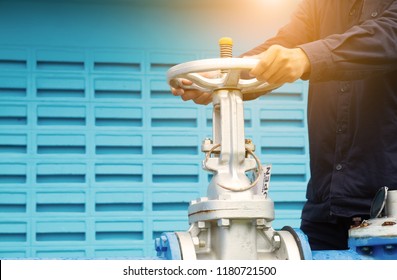 Close Up Of Man Hands Operating A Control Valve Installed On Tap Water Pipe Or Water Supply Pipe Network.