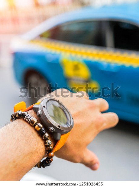Close up of man
hands with outdoor watch and stone bracelet. Man raising him hand
for calling taxi in
Istanbul.
