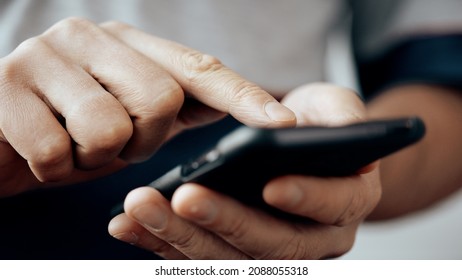 Close up of man hands are texting message on mobile smart phone for communication and chatting on social online. He is typing SMS or message in messanger app for smart phone