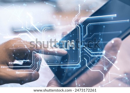 Close up of man hands using tablet with creative glowing eSim hologram on blurry background. Embedded sim and cellular mobile technology concept. Double exposure