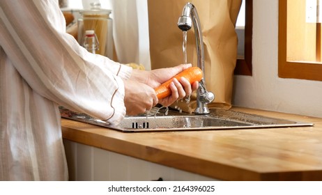 Close up Man hands wash Carrot in kitchen. Cleaning fresh vegetable fruit prepare  vegetable make organic salad healthy food. - Powered by Shutterstock