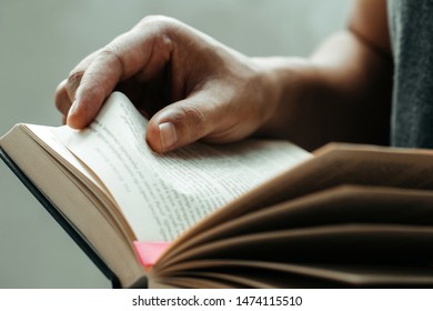 Close up man hands.Young man opening and reading a book,  - Shutterstock ID 1474115510