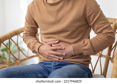 Close Up Man Having Stomach Ache So Pain Illness,food Poisoning In Young Man Have A Bacteria Infection.Unhappy Male Painful On Stomach Vomit And Tried Need Medicine And Rest.Health Care Concept