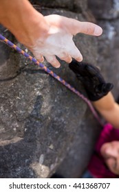 Close Up Man Helping Woman In Rock Climbing