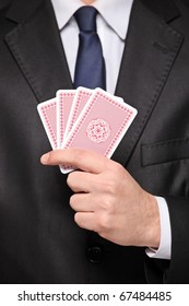 A Close Up Of A Man Holding A Four Cards Playing Poker