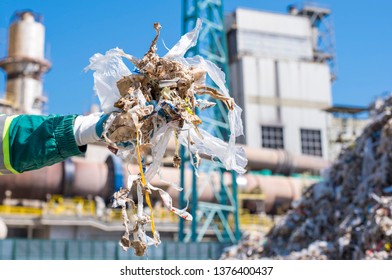 Close Up Of Man Holding Shredded Municipal Waste In Front Of Rotary Cement Kiln Used As Alternative Fuel