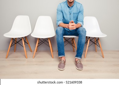 Close Up Of Man In Jeans Waiting For Smth While Sitting On Chair