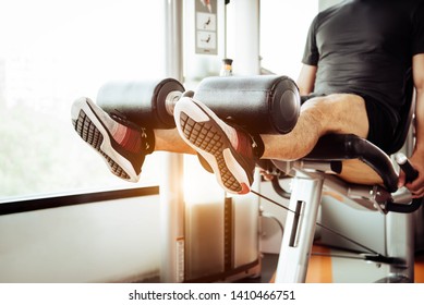 Close up of man lifting weight by two legs for stretching muscle at fitness gym at private condominium background. Sport and People lifestyles concept. - Powered by Shutterstock