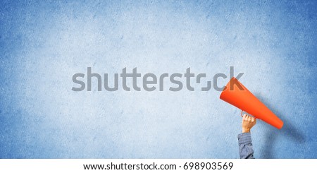 Close of man making announcement in paper trumpet