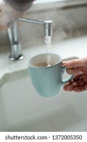 Close Up Of Man Making Hot Drink From Boiling Water Tap