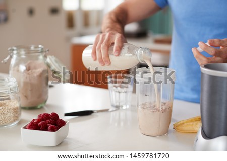 Close Up Of Man Making Protein Shake After Exercise At Home