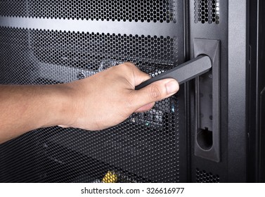 close up man open server rack door