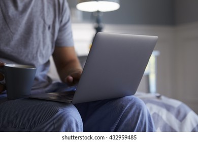 Close Up Of Man In Pajamas Using Laptop Computer