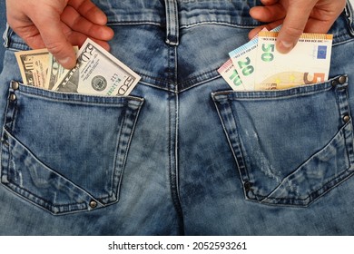 Close Up Man Pickpocket Hands Pull And Steal Several Different Value US Dollar And Euro Paper Currency Banknotes From Jeans Back Pockets, Low Angle View