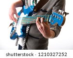 Close up man playing a guitar, unrecognizable person over white background, studio shot