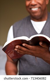 Close up of a man reading the Bible.