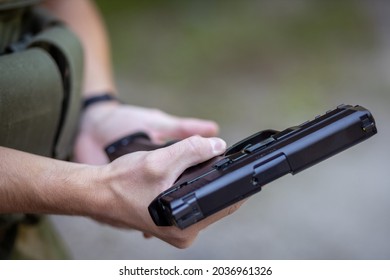 Close Up Of A Man Reloading An Airsoft Pistol