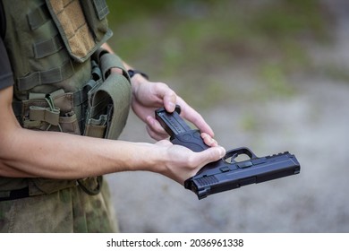 Close Up Of A Man Reloading An Airsoft Pistol