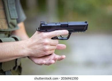 Close Up Of A Man Reloading An Airsoft Pistol