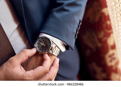 Close up of a man setting up his watch.