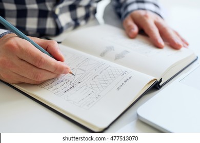 Close up of man sketching graphic sketch in office