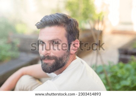 Close up of man smiling in backyard