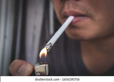 Close up man smoking a cigarette.Healthy concept. - Powered by Shutterstock