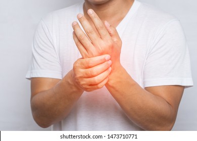 Close Up Of Man Suffering From Pain In Hand Or Wrist