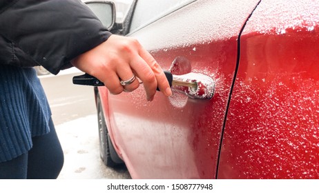 Close Up Of Man Trying To Oper Frozen Car Lock