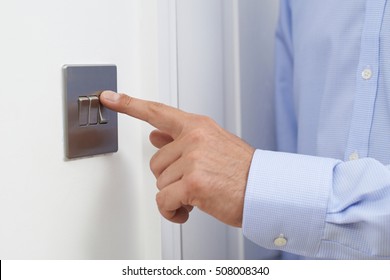 Close Up Of Man Turning Off Light Switch