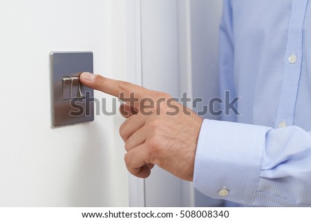 Close Up Of Man Turning Off Light Switch