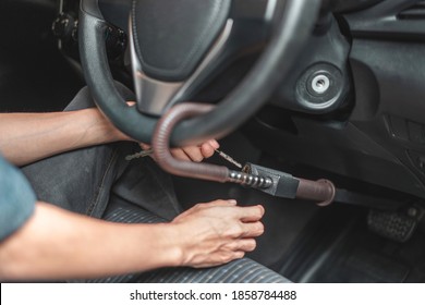 Close up of man use key locking steering wheel for security, Anti thief steal a car, Selective focus.