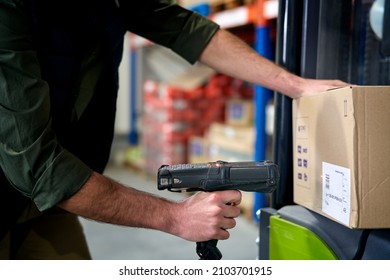 Close up of man using bar code reader in a warehouse                               