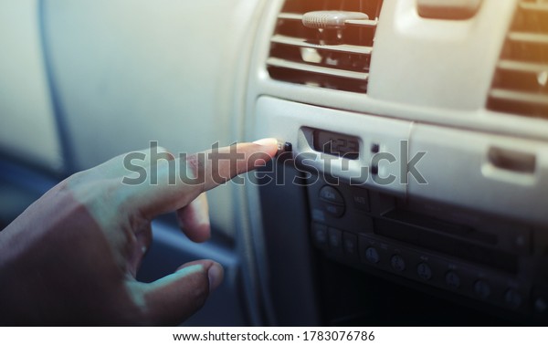 close up of a man\
using a clock interior\
car