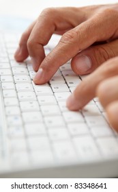 Close up man using computer keyboard