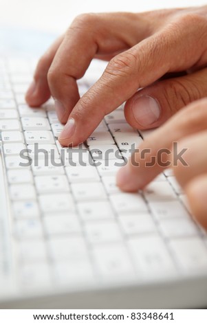 Close up man using computer keyboard