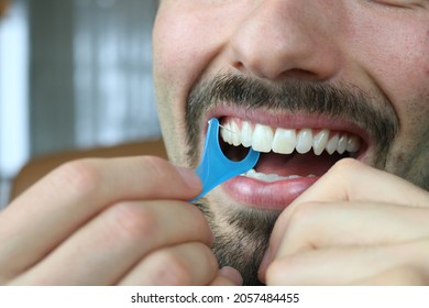 Close Up Of Man Using Dental Floss Pick, Cleaning His Mouth 