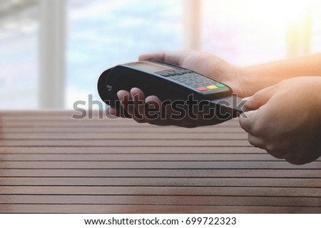 Close up a man using EDC machine for credit card at cashier counter